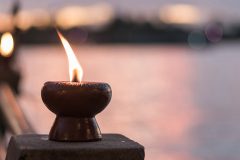 Spirituality and tranquility abstract concept with candle light illumination and golden sunset sky